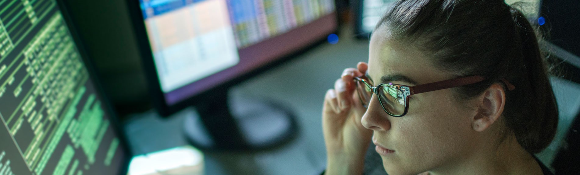Woman Surrounded By Monitors