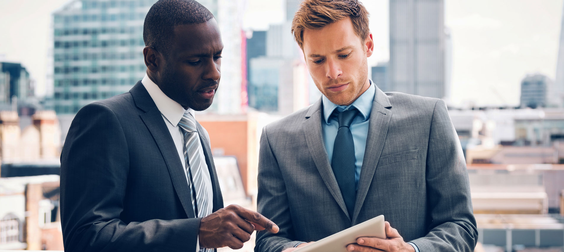 Business People Discussing Project On Digital Tablet