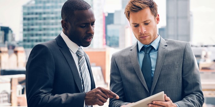 Business People Discussing Project On Digital Tablet