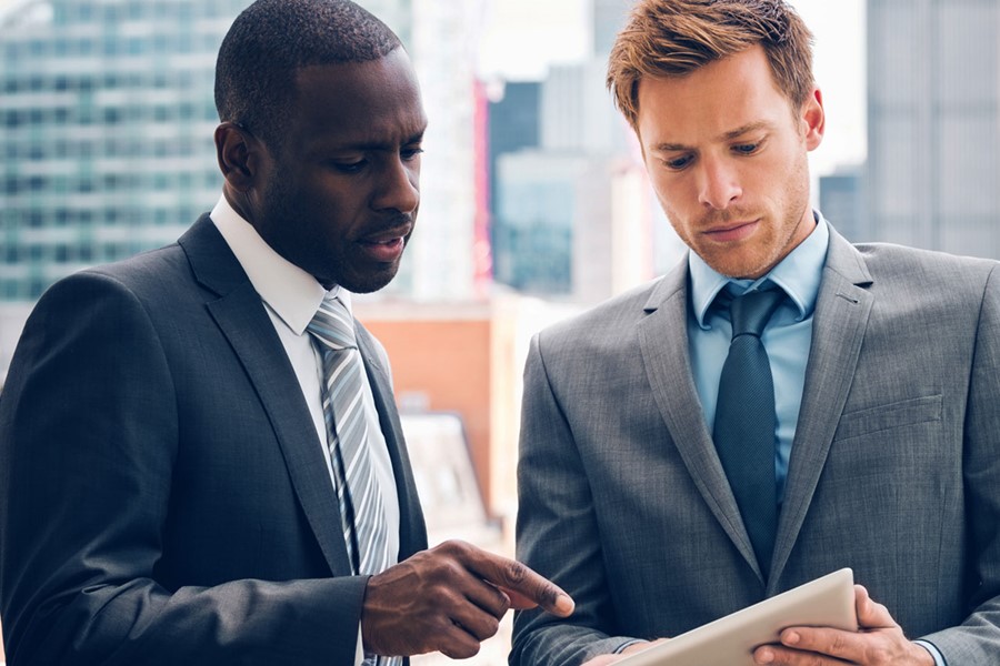 Business People Discussing Project On Digital Tablet