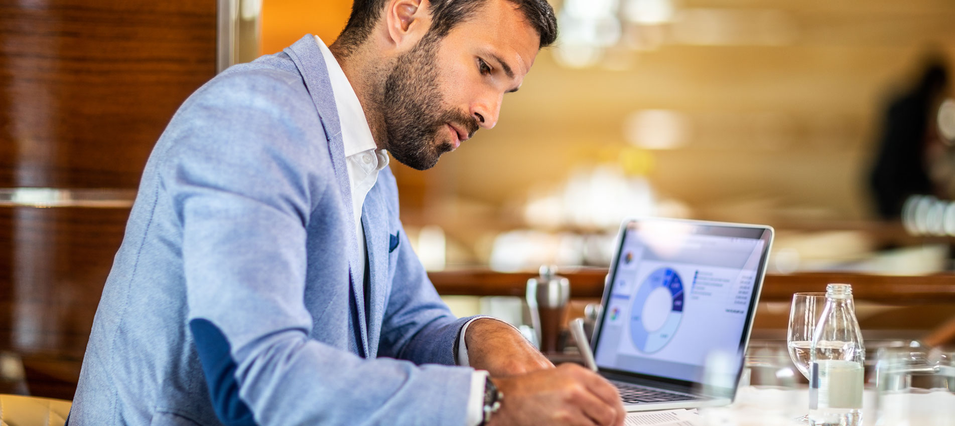 Man Writing On A Document While Sitting In A Restaurant