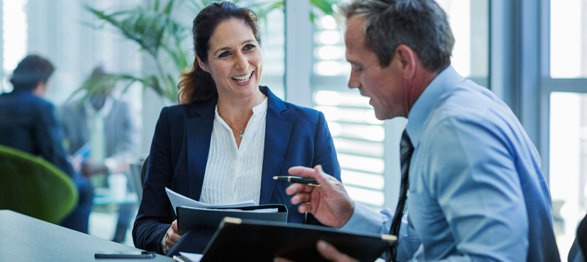 Businesswoman Discussing With Colleague