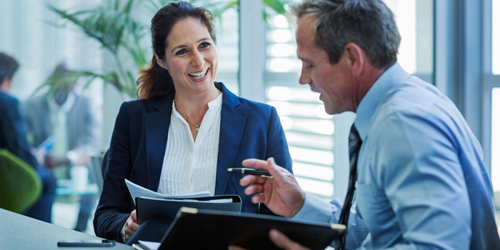 Businesswoman Discussing With Colleague