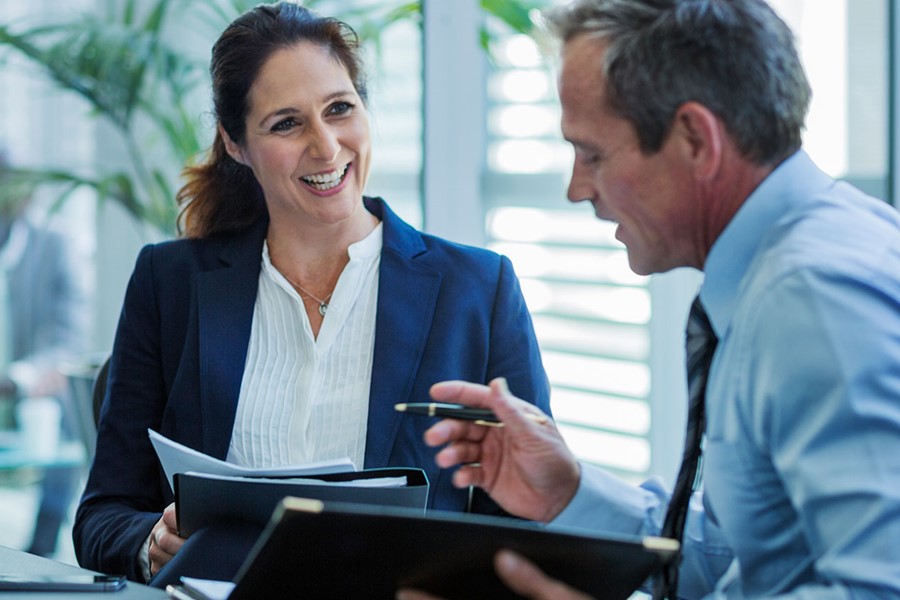 Businesswoman Discussing With Colleague