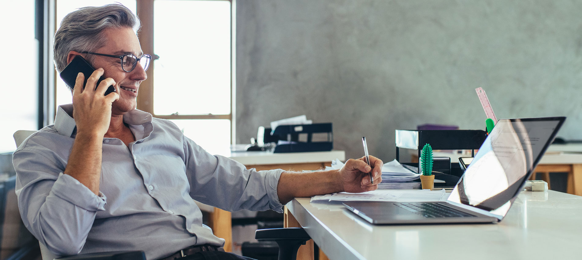Businessman In Office Talking On Phone
