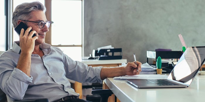 Businessman In Office Talking On Phone