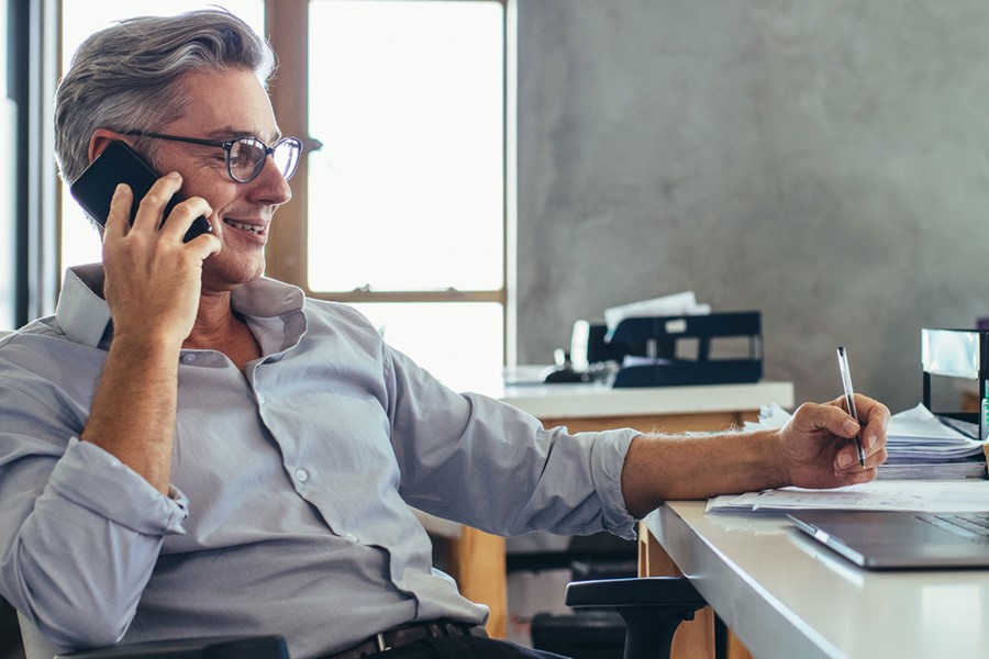 Businessman In Office Talking On Phone