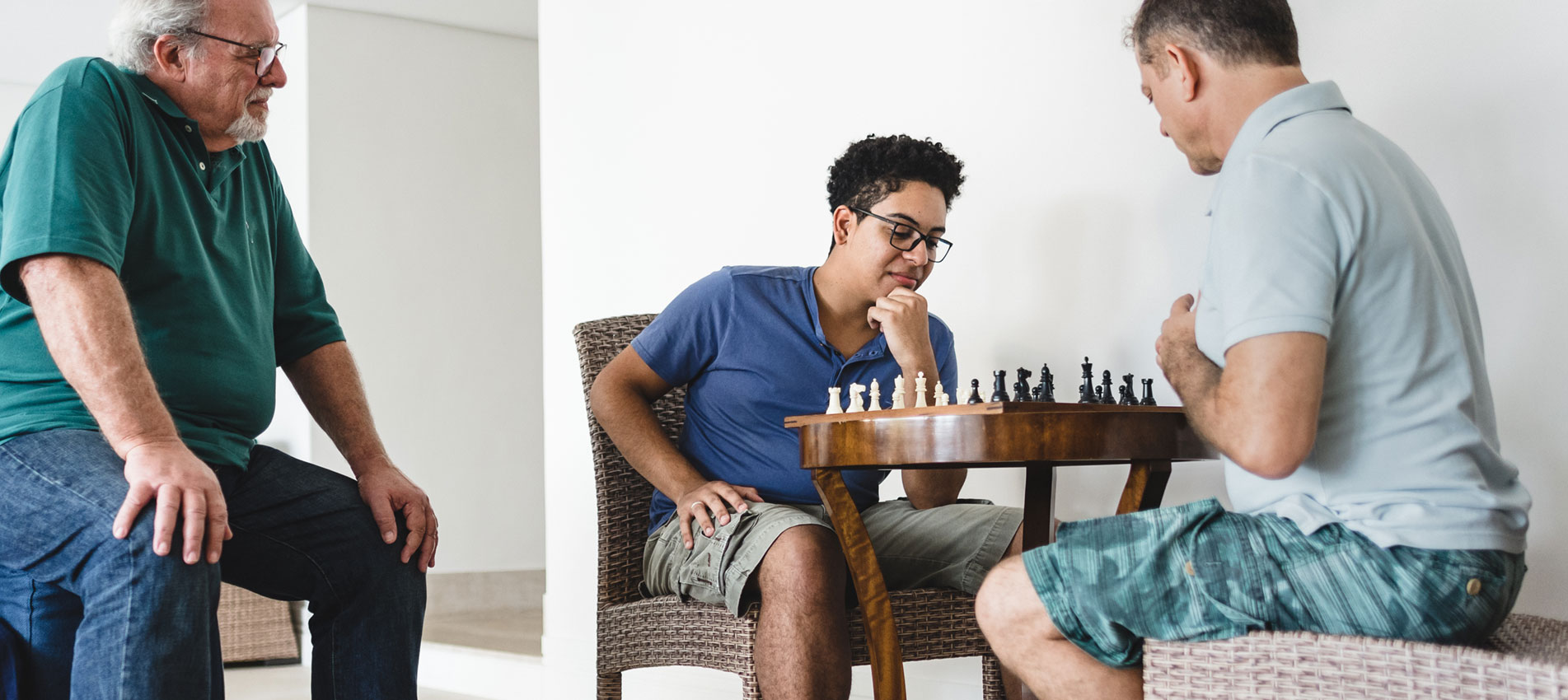 Men Of Three Generations During A Game Of Chess