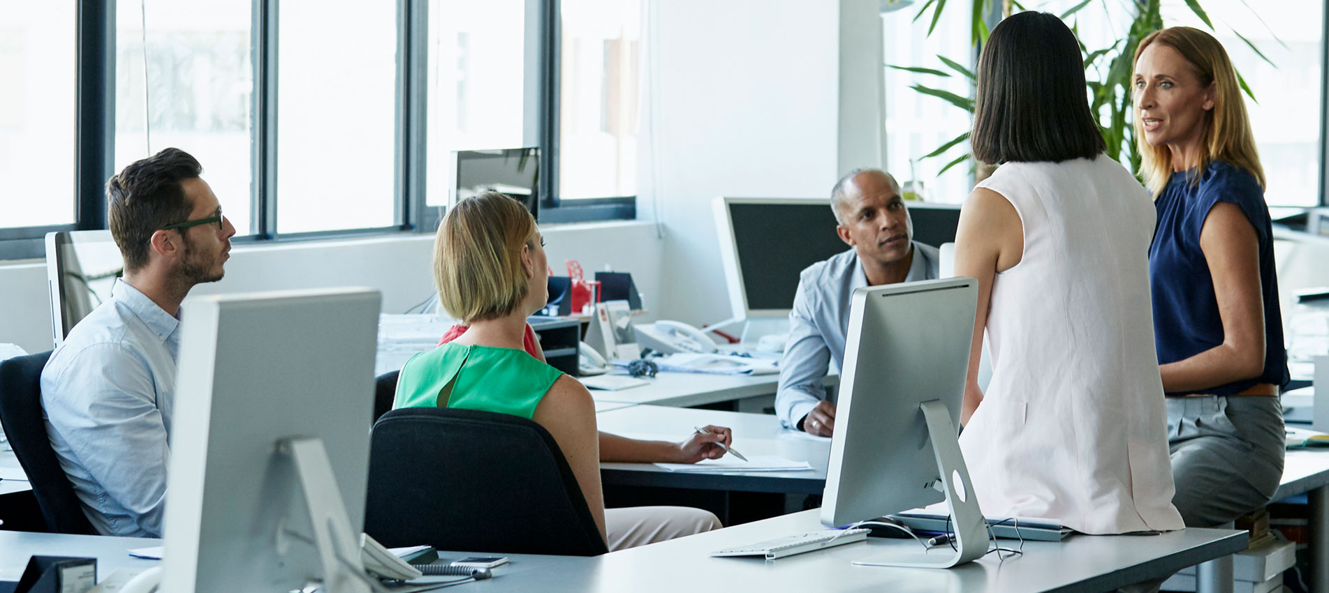 Confident Professionals Discussing In Office