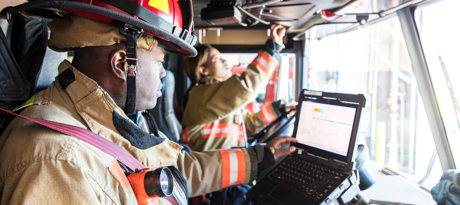 Firefighter In The Drivers Seat Of The Fire Engine