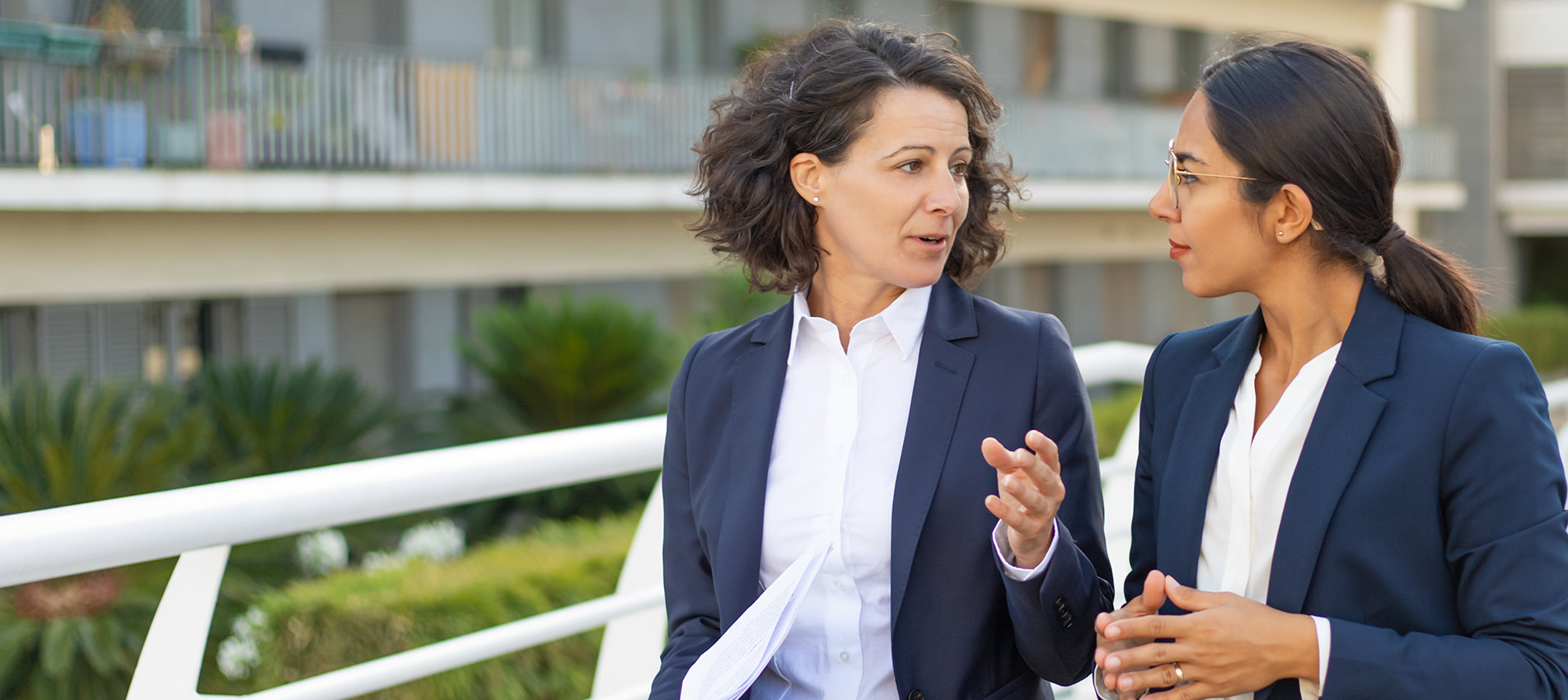 Focused Female Professionals Discussing Project