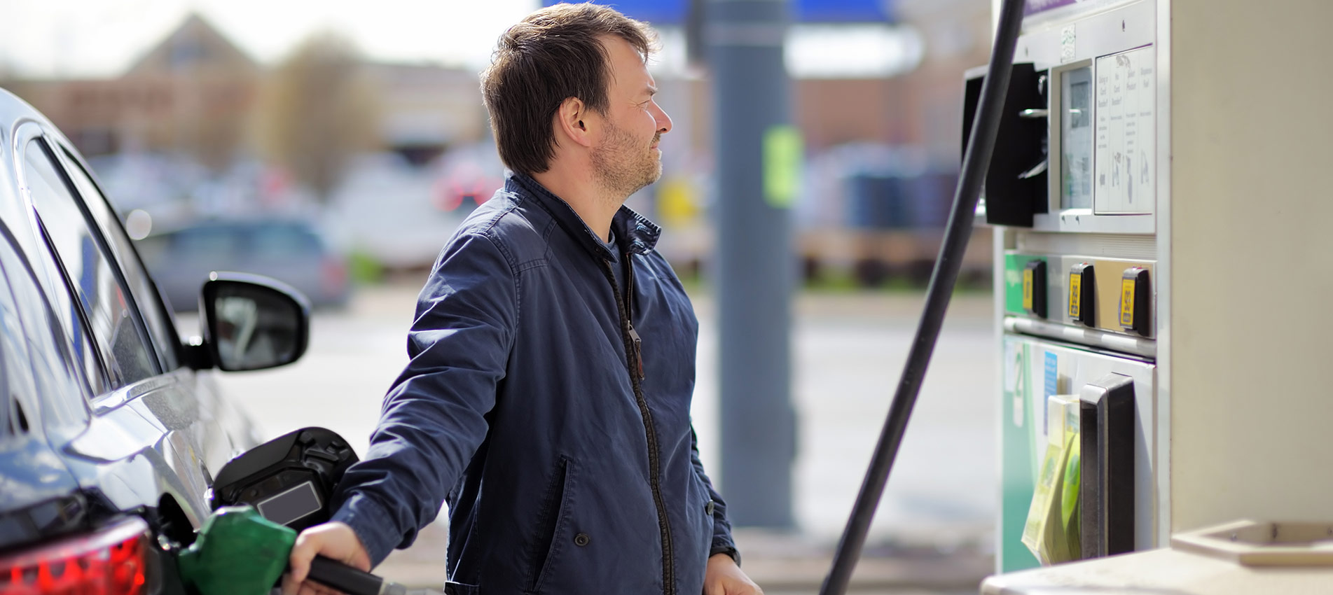Middle Age Man Filling Gasoline Fuel In Car Holding Nozzle