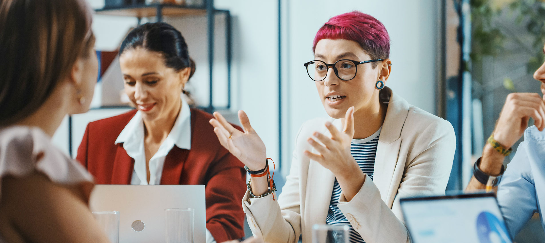Beautiful Specialist With Short Pink Hair Talks About Firm Strategy With Diverse Team Of Professional Businesspeople
