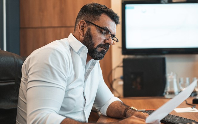 Mature Man Using Laptop In Office