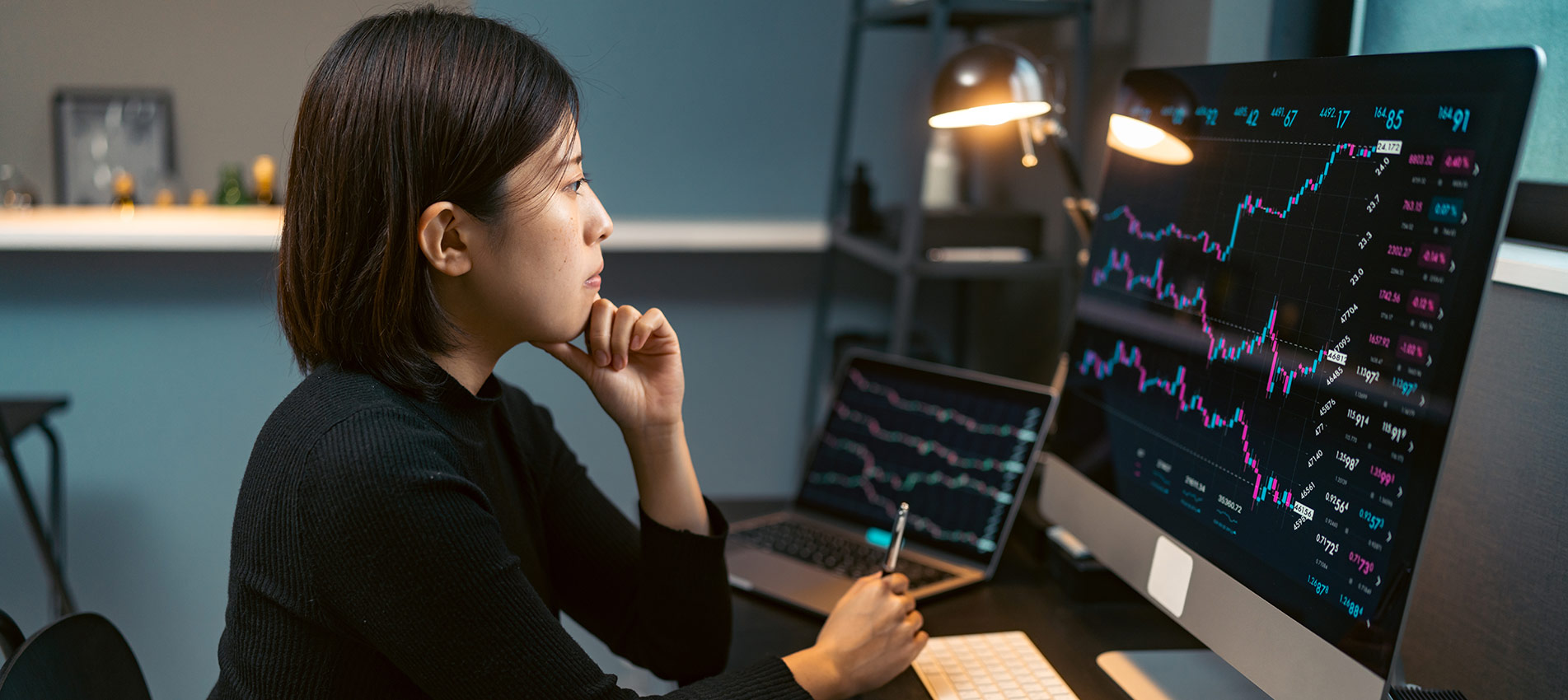 Young Woman Doing Cryptocurrency Business Trading On Her Computer At Home At Nigh (1)
