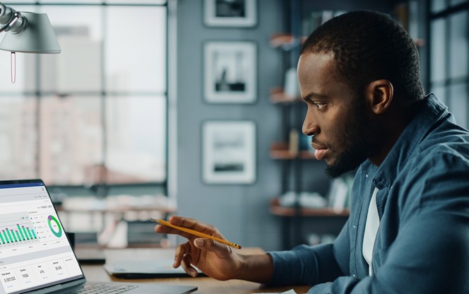 Black African American Specialist Working On Laptop Computer