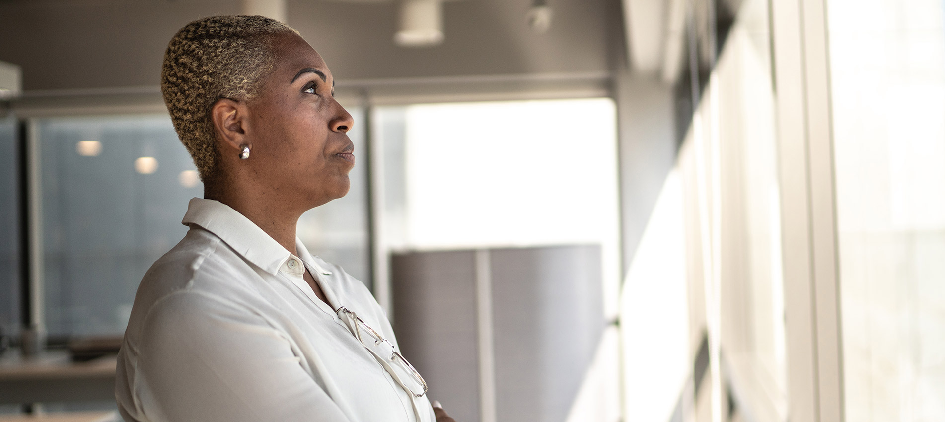 Serious Businesswoman Looking Through The Window