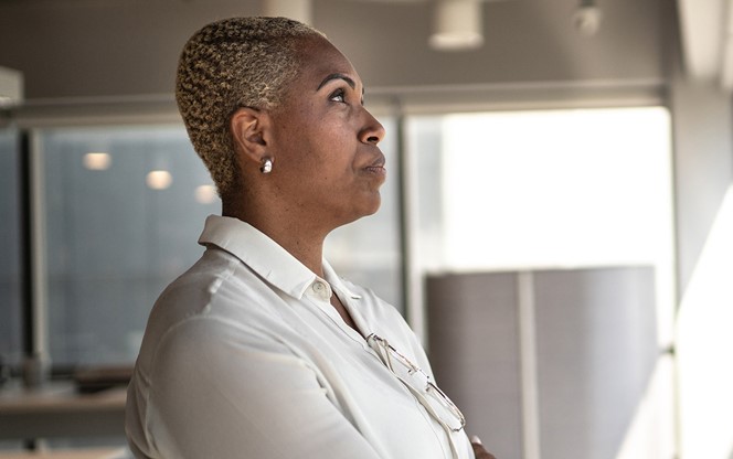 Serious Businesswoman Looking Through The Window
