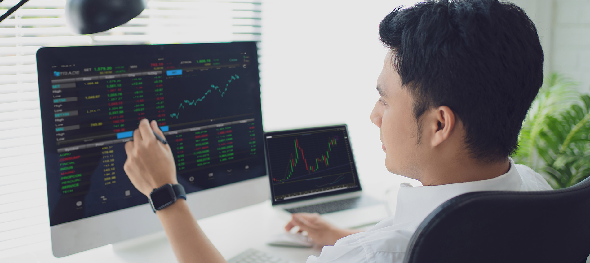 Young Businessman Or Trader Pointing On The Data On Computer Screen With Pen While Working His Modern Office