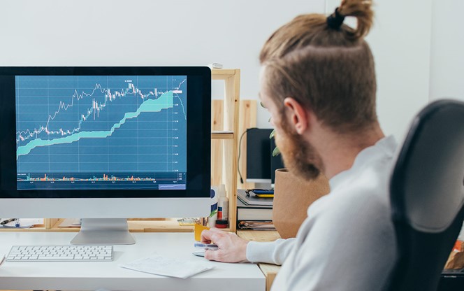Two Colleagues Analyzing A Financial Chart On A Computer