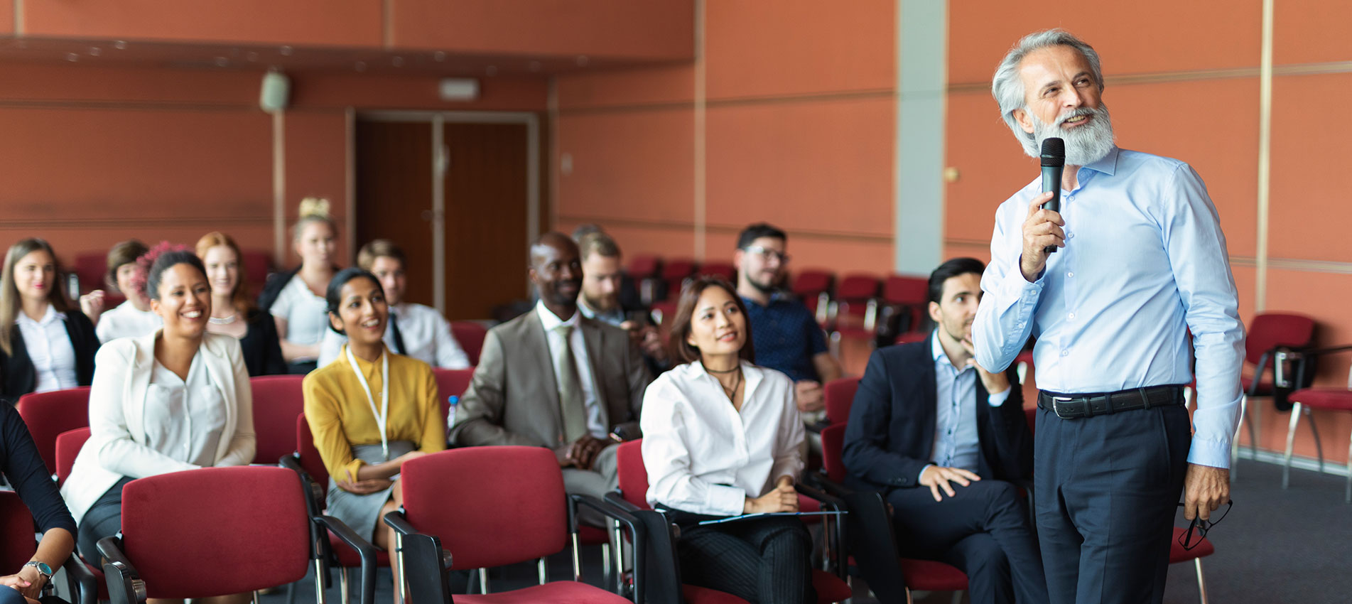 A Mature Presenter At A Seminar