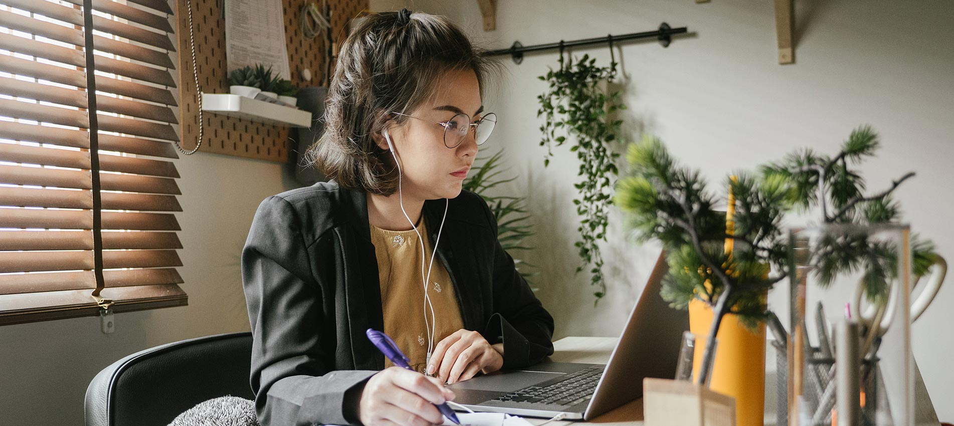 Asian woman using laptop during conference call at home