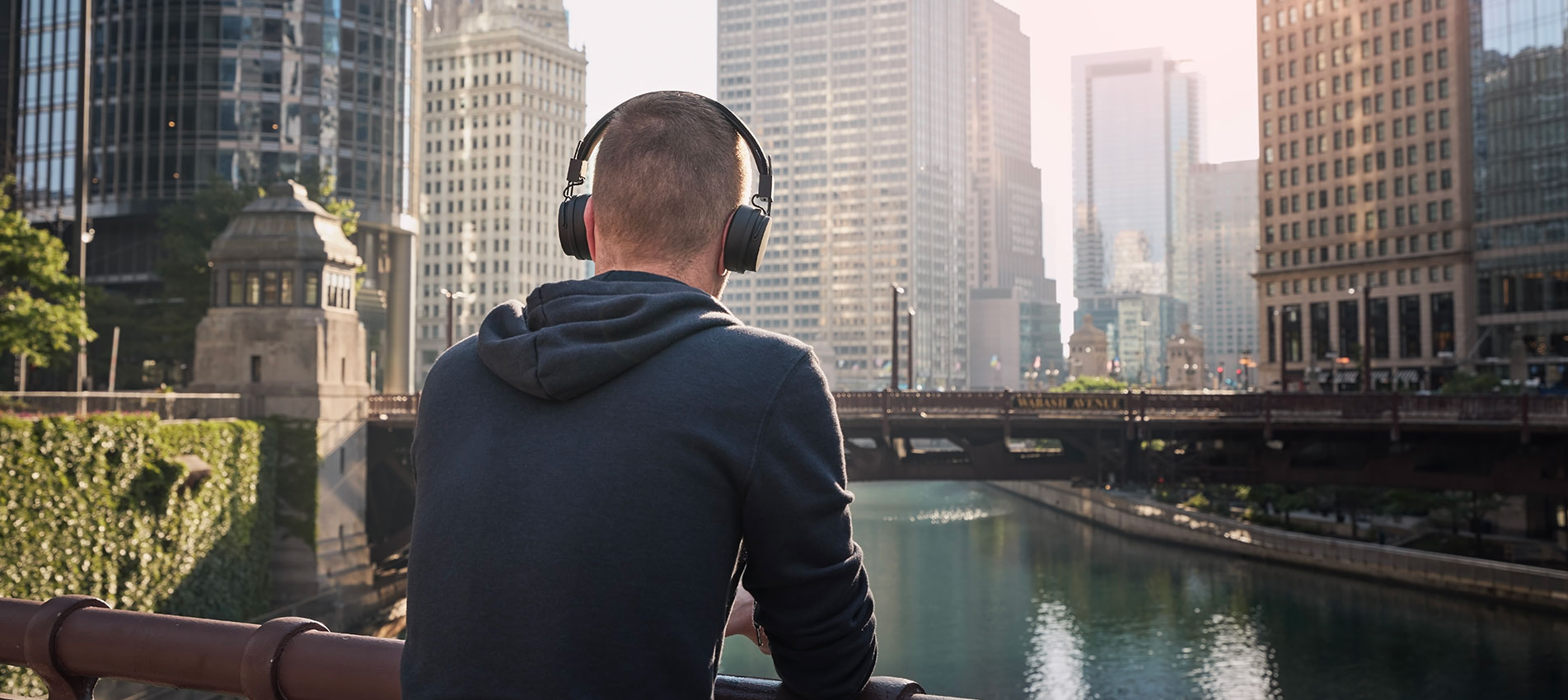 Pensive Man With Wireless Headphones During City Walk