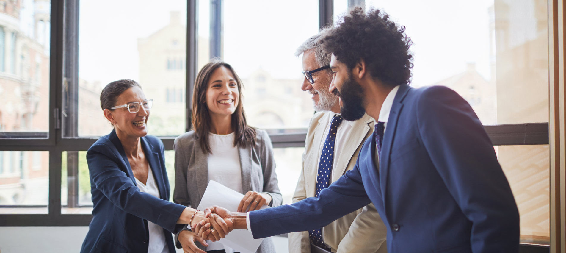 Team Of Professionals In A Meeting Smiling