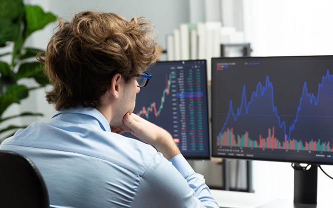 Young Stock Trader Looking On Dynamic Exchange Investment On Pc