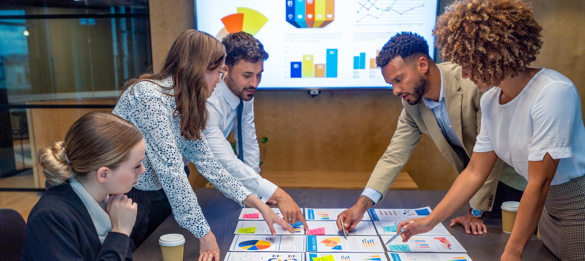 Colleagues Are Reviewing Financial Graphs Data Charts At A Business Presentation