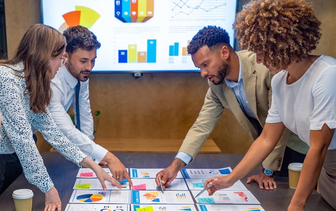 Colleagues Are Reviewing Financial Graphs Data Charts At A Business Presentation