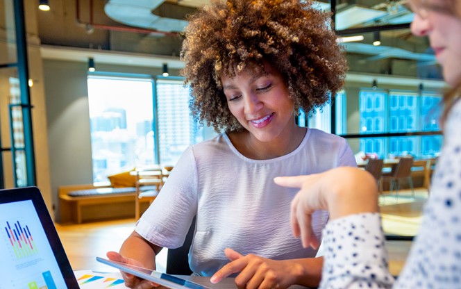 Business Colleagues Discussing Charts And Graphs On A Laptop Computer