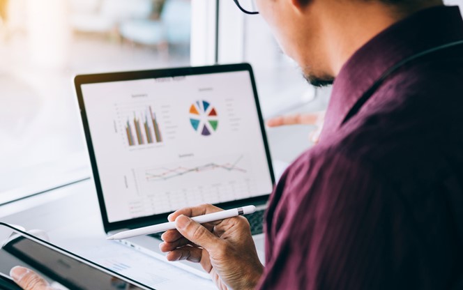 Business Man Reviewing Data On A Screen