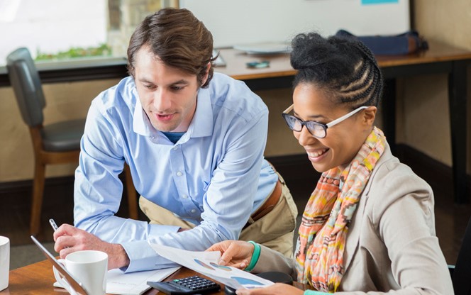 Business Colleagues Analyzing Charts On A Screen