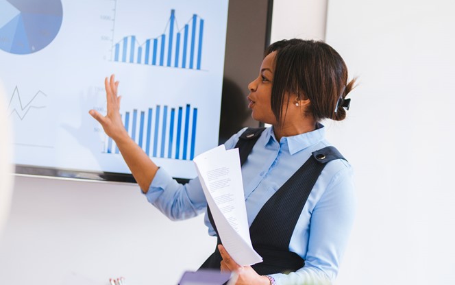 Businesswoman Is Showing Some Graphs To Her Coworkers