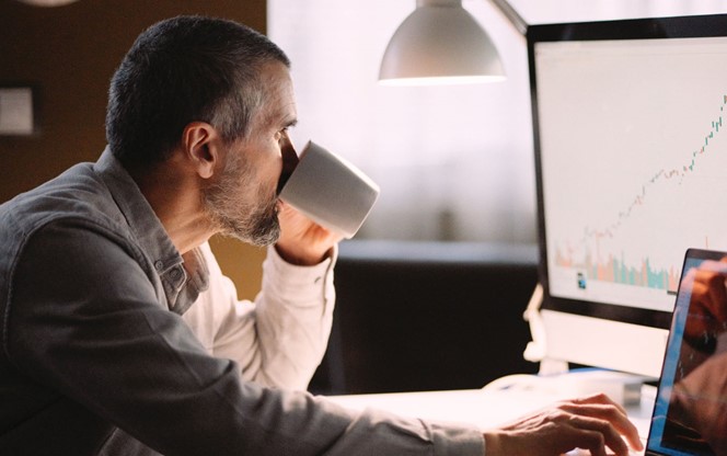 Stock Trader Studying The Stock Market On Screen