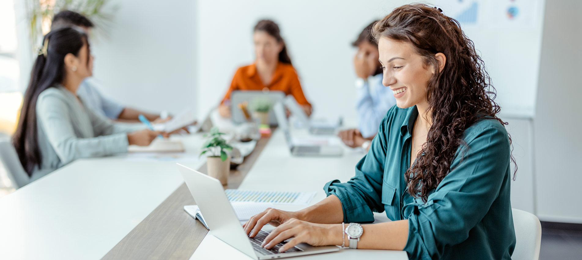 Businesswoman Sitting At The Office Table Using A Laptop