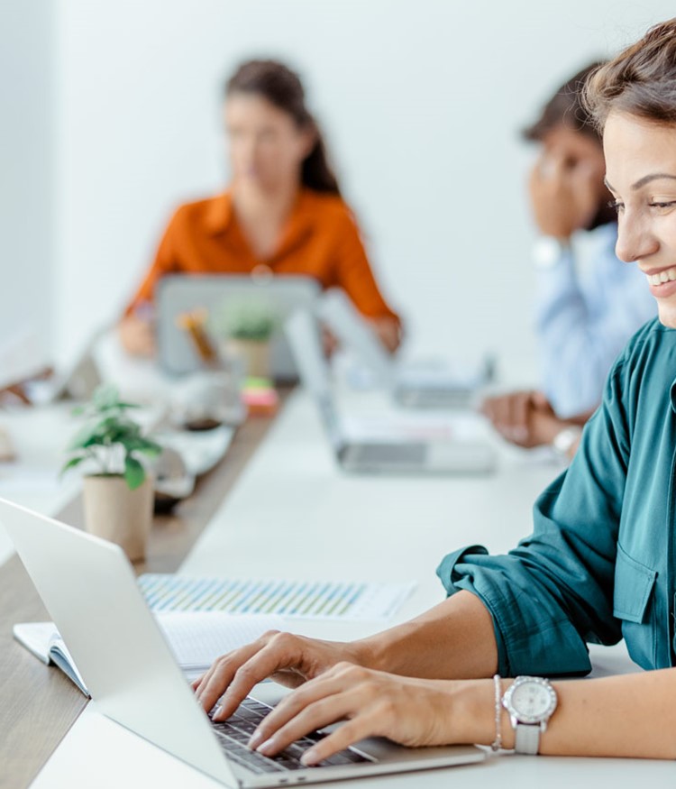 Businesswoman Sitting At The Office Table Using A Laptop