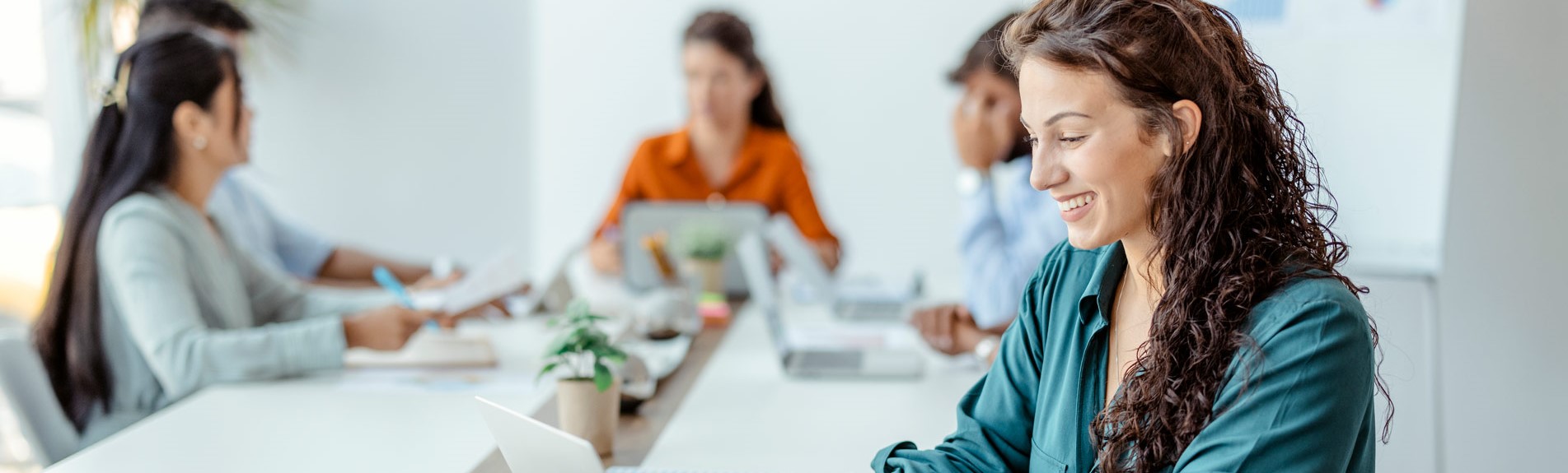 Businesswoman Sitting At The Office Table Using A Laptop