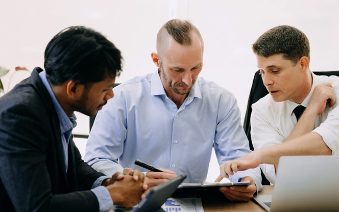 Team Of Analyst Reviewing Data On Screen