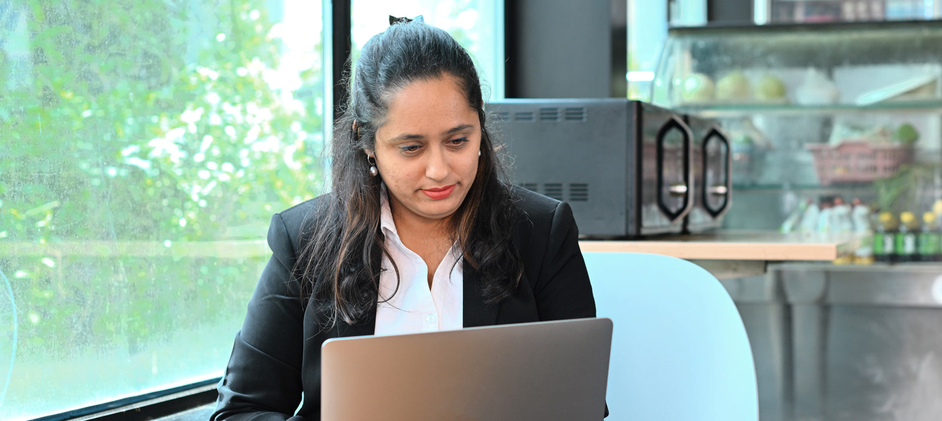 Business Woman Working On Laptop While Siting At A Cafe