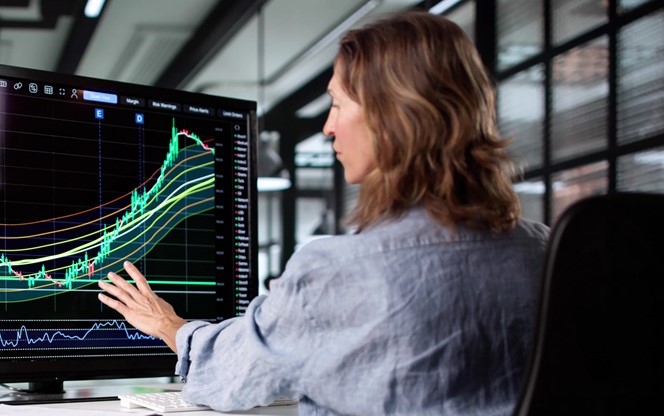 Businesswoman Analyzing Stock Market Trends On Screen