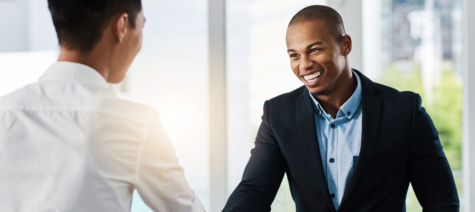 Young Businessmen Shaking Hands In A Modern Office