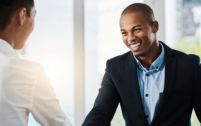 Young Businessmen Shaking Hands In A Modern Office