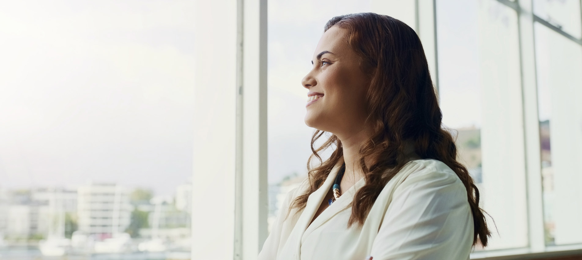 Businesswoman Smiling Looking Outside The Window