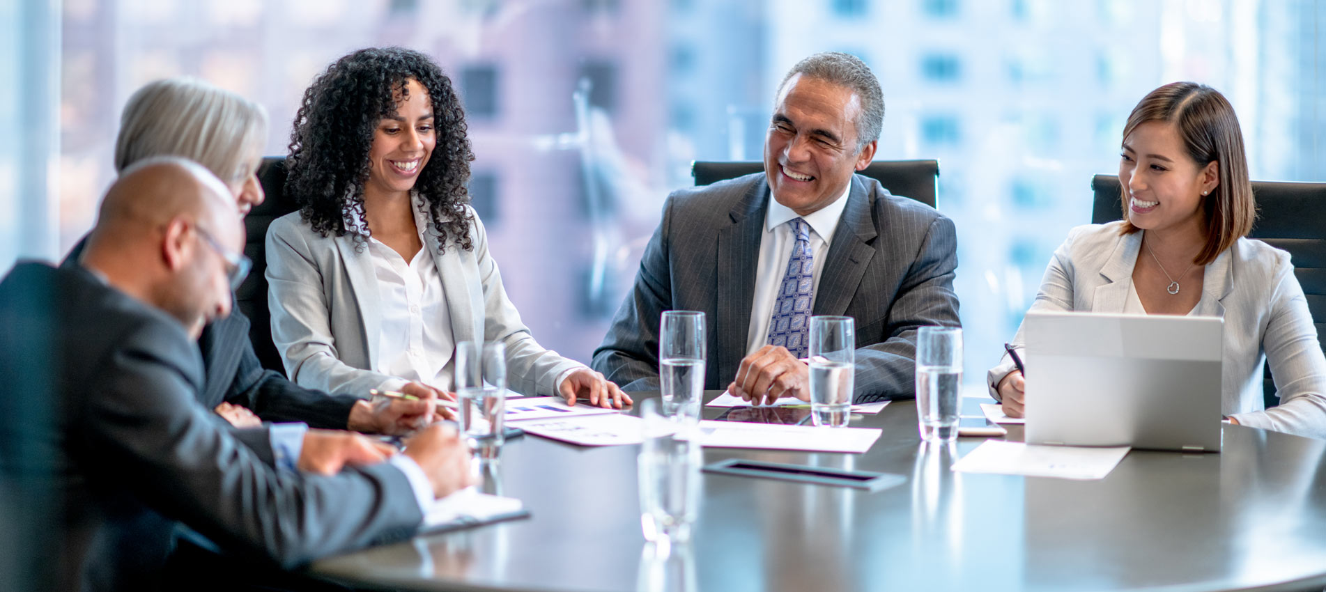 Business Professionals Having A Discussion Around A Boardroom Table