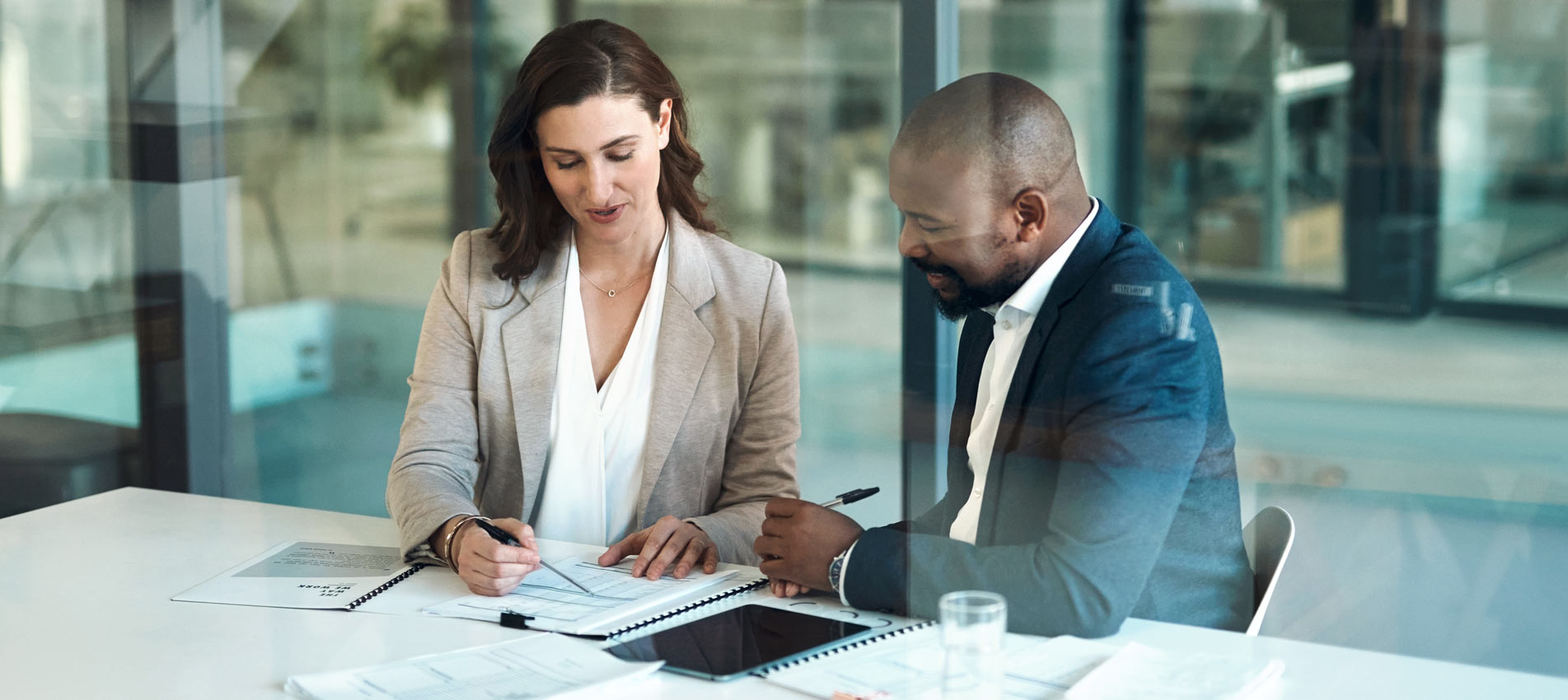 Business Colleagues Reviewing Investment Data At The Office