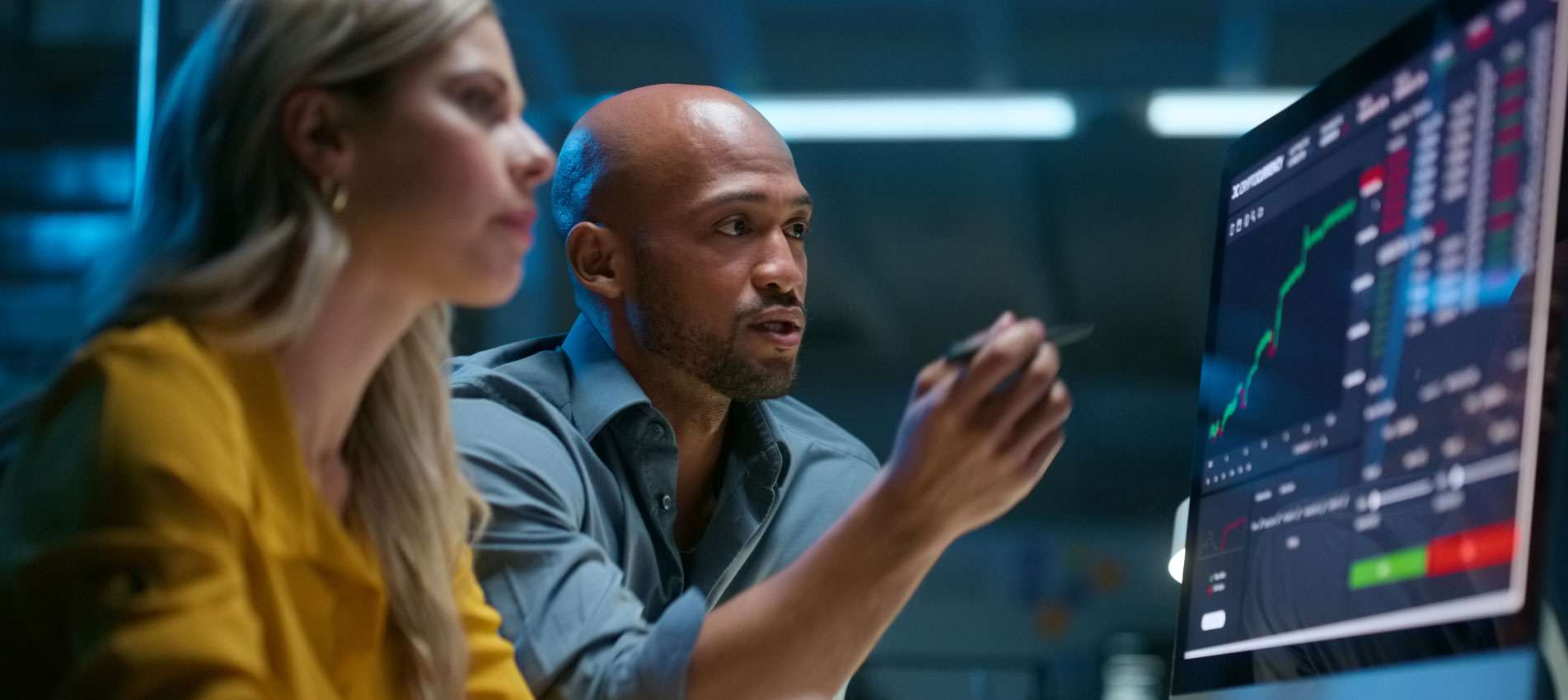 Business Colleagues Analyzing The Market On A Screen